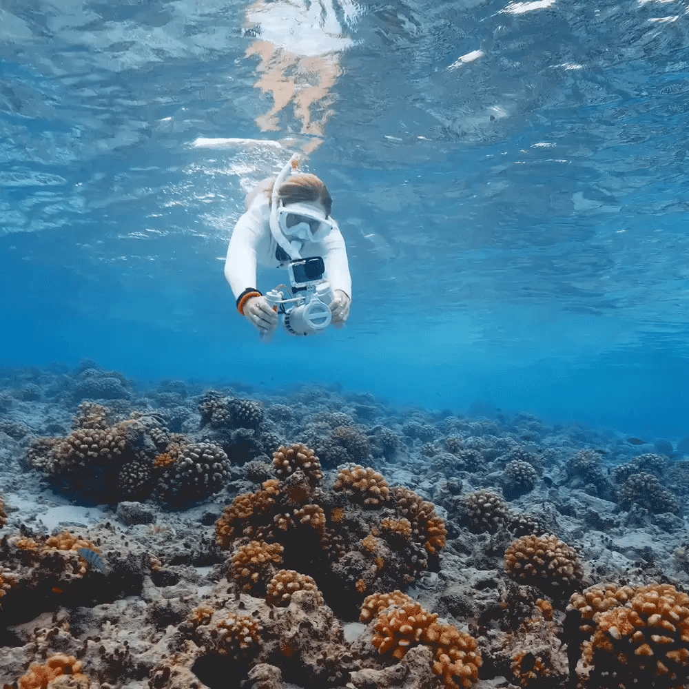 Diver using a LEFEET underwater scooter with camera equipment
