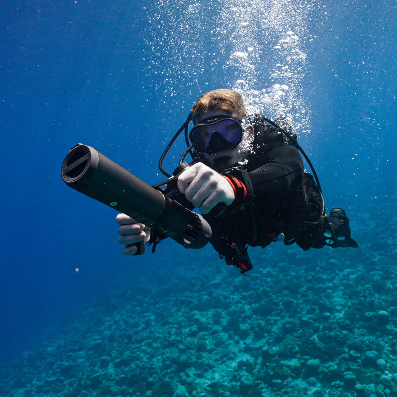 Snorkeler using a handheld LEFEET underwater scooter